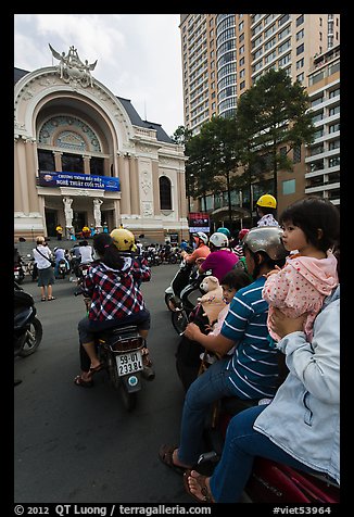 Family on motorbike watching performance at opera house. Ho Chi Minh City, Vietnam