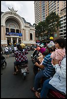 Family on motorbike watching performance at opera house. Ho Chi Minh City, Vietnam (color)