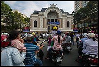 Families gather on motorbikes to watch performance in front of opera house. Ho Chi Minh City, Vietnam ( color)