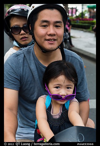 Family on motorbike with sunglasses. Ho Chi Minh City, Vietnam (color)
