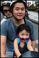 Family on motorbike with sunglasses. Ho Chi Minh City, Vietnam (color)