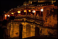 People enjoy Japanese Bridge lit solely by lanterns. Hoi An, Vietnam (color)