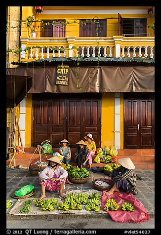 Banana vendors and historic house. Hoi An, Vietnam (color)