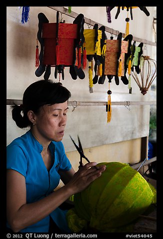 Woman working on paper lantern. Hoi An, Vietnam (color)