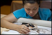 Woman working on a silk embroidery piece. Hoi An, Vietnam ( color)