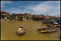 Women crossing the Thu Bon River in a rowboat. Hoi An, Vietnam ( color)