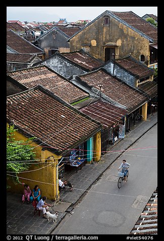 Elevated view of street with woman on bicycle. Hoi An, Vietnam