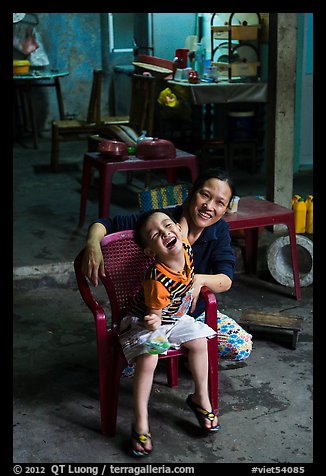 Boy and woman in kitchen. Hoi An, Vietnam (color)