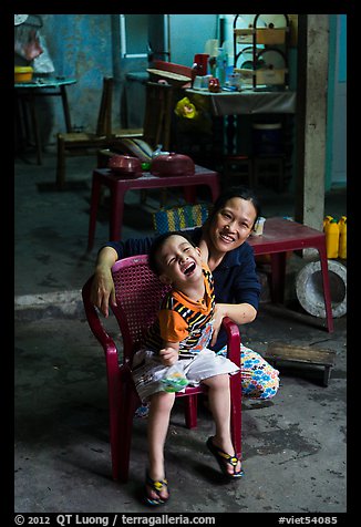 Boy and woman in kitchen. Hoi An, Vietnam