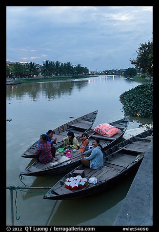 Family having dinner on boats at dusk. Hoi An, Vietnam (color)