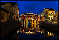 Japanese covered bridge reflected in canal at night. Hoi An, Vietnam (color)