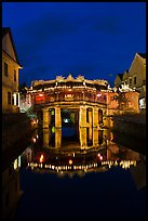 Illuminated Japanese covered bridge reflected in canal. Hoi An, Vietnam (color)