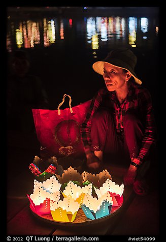 Woman selling floating candles at night. Hoi An, Vietnam