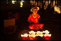 Boy selling candle lanterns at night. Hoi An, Vietnam (color)