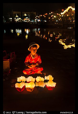 Boy selling candle lanterns by the river. Hoi An, Vietnam (color)