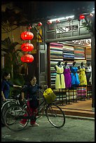 Women with bicycles in front of taylor shop. Hoi An, Vietnam ( color)
