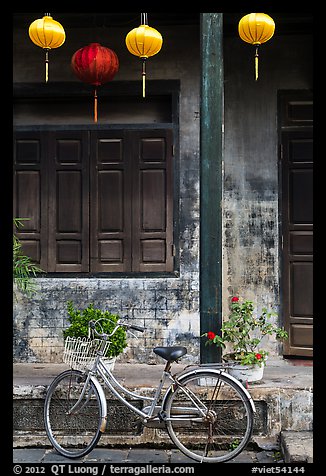 Bicycle and facade with lanterns. Hoi An, Vietnam