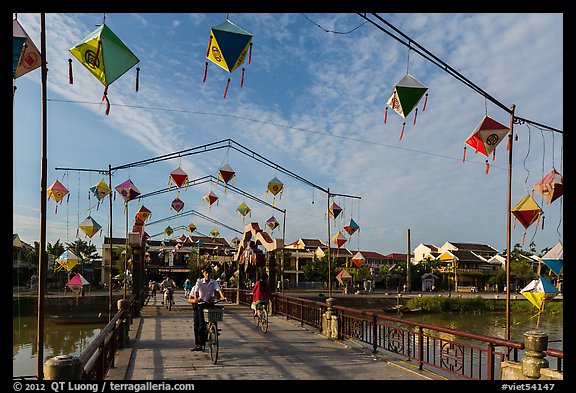 Schoolchildren cross Cam Nam bridge. Hoi An, Vietnam