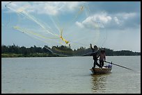 Fisherman throwing net, Thu Bon River. Hoi An, Vietnam (color)