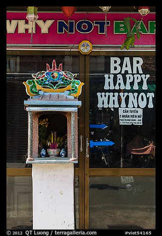 Curbside altar in front of bar. Hoi An, Vietnam