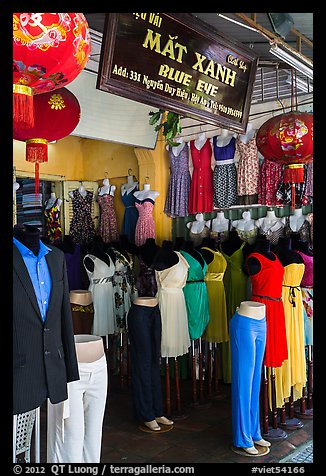 Colorful outfits and lanterns in textile shop. Hoi An, Vietnam