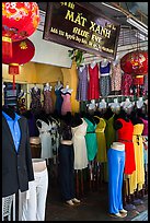 Colorful outfits and lanterns in textile shop. Hoi An, Vietnam (color)
