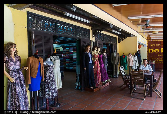 Man sitting outside textile store. Hoi An, Vietnam (color)