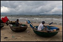 Fishermen mending nets in coracle boats. Da Nang, Vietnam ( color)