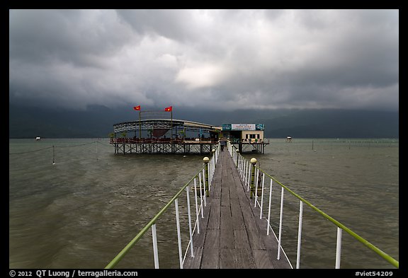 Pier leading to restaurant on stilts. Vietnam (color)