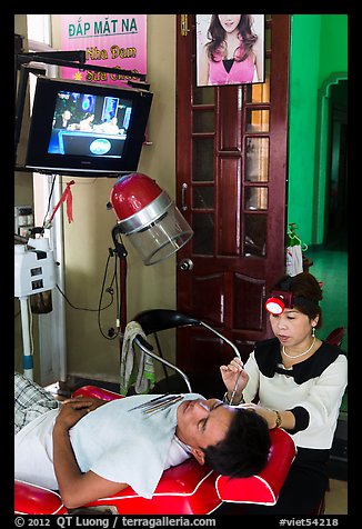 Man getting ear cleaning. Vietnam (color)