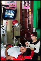 Man getting ear cleaning. Vietnam ( color)