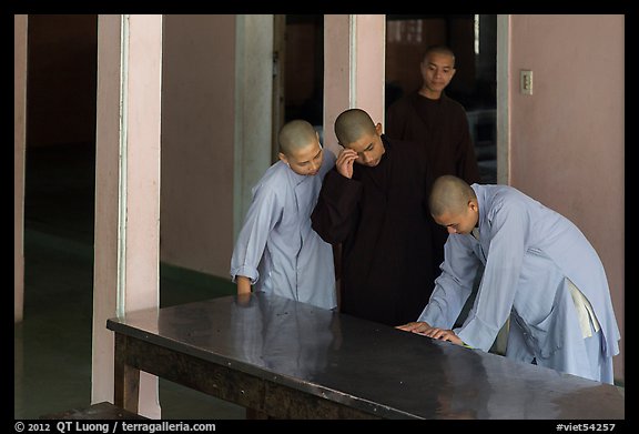 Monks looking at book, Thien Mu pagoda. Hue, Vietnam