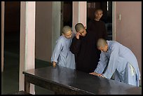 Monks looking at book, Thien Mu pagoda. Hue, Vietnam (color)