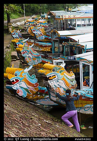 Woman pushes dragon boat. Hue, Vietnam