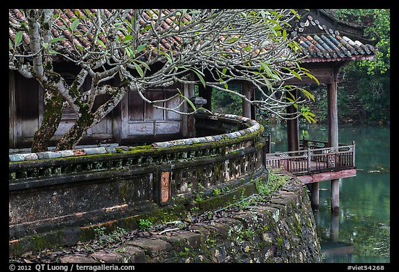 Luu Khiem Lake edge with stone fence and pavilion, Tu Duc Tomb. Hue, Vietnam