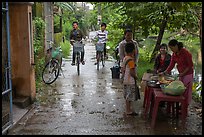 Canalside street with bicyclists and food stand, Thanh Toan. Hue, Vietnam (color)