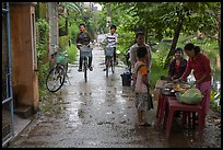 Canalside street with bicyclists and food stand, Thanh Toan. Hue, Vietnam ( color)
