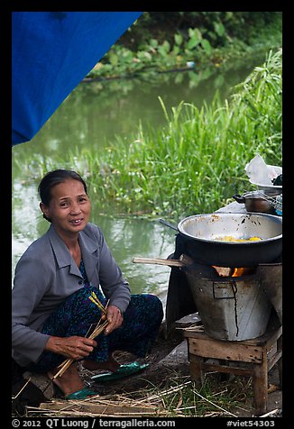 Woman cooking canalside, Thanh Toan. Hue, Vietnam