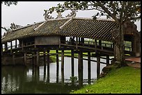 Friends sitting inside covered bridge, Thanh Toan. Hue, Vietnam (color)