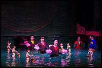 Puppeters coming from behind the bamboo screen after performance, Thang Long Theatre. Hanoi, Vietnam ( color)