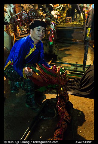 Water puppet artist holding dragon backstage, Thang Long Theatre. Hanoi, Vietnam