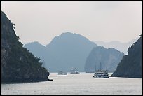 Tour boats and islands in mist. Halong Bay, Vietnam (color)