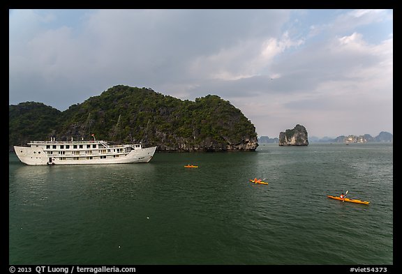 Tour boat and sea kayaks. Halong Bay, Vietnam (color)