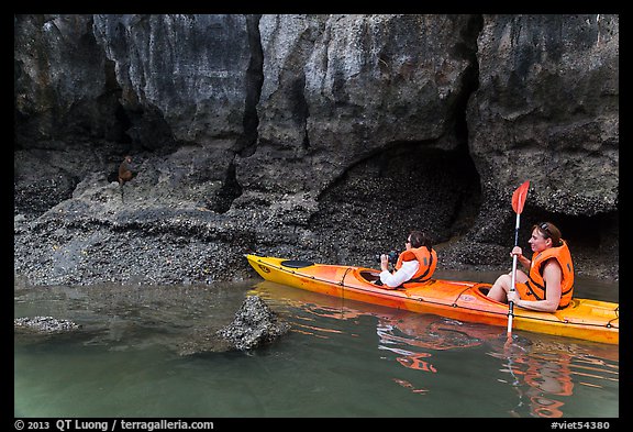 Sea kayakers approaching monkey. Halong Bay, Vietnam