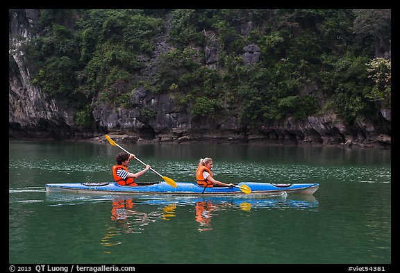 Sea kayakers on emerald waters. Halong Bay, Vietnam (color)
