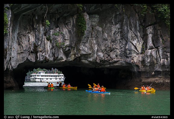 Kayaks floating through Luon Can tunnel. Halong Bay, Vietnam (color)