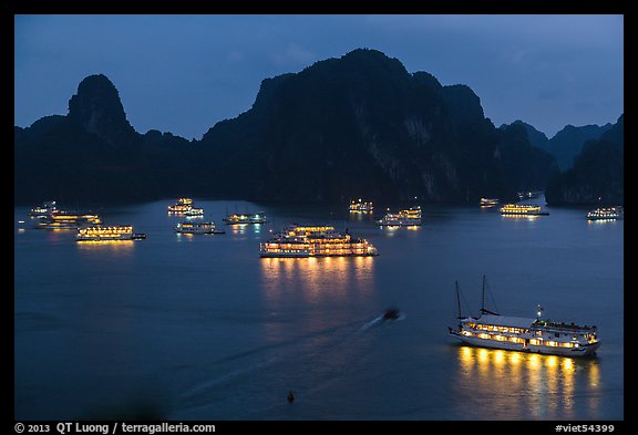 Flotilla of tour boats and islands at night. Halong Bay, Vietnam