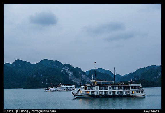 Two tour boats at dawn. Halong Bay, Vietnam
