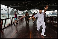 Morning Tai Chi session on tour boat deck. Halong Bay, Vietnam (color)