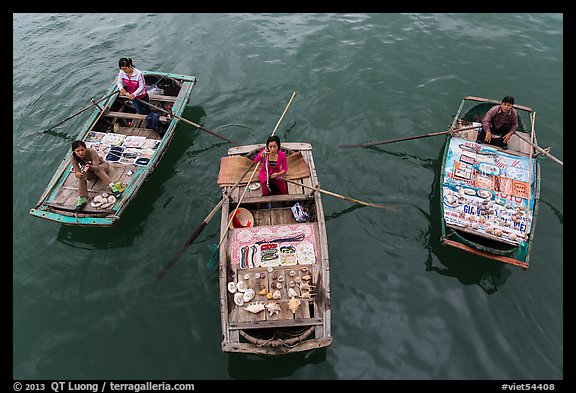 Women selling sea shells and perls from row boats. Halong Bay, Vietnam (color)